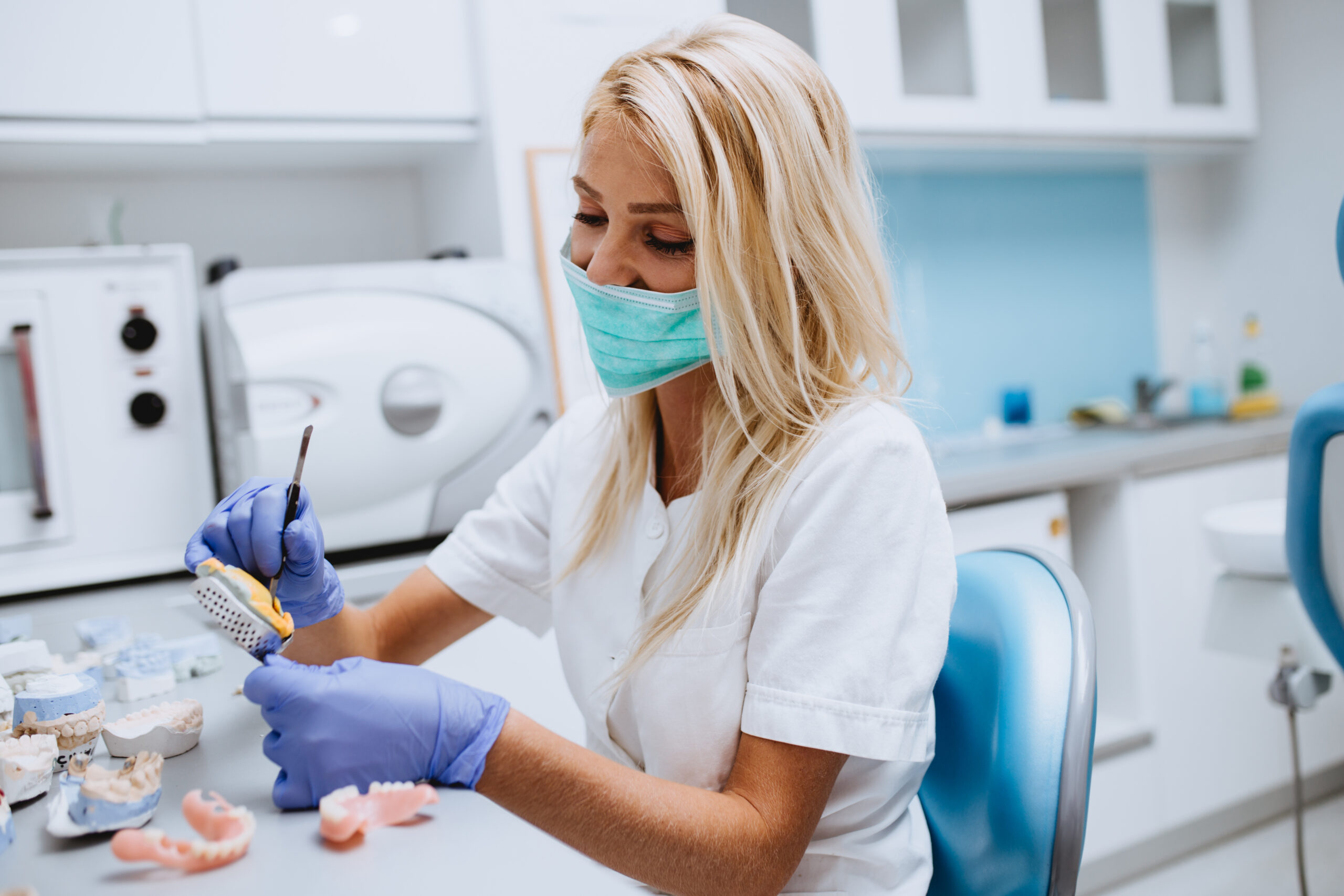 Dental technician doing denture repairs