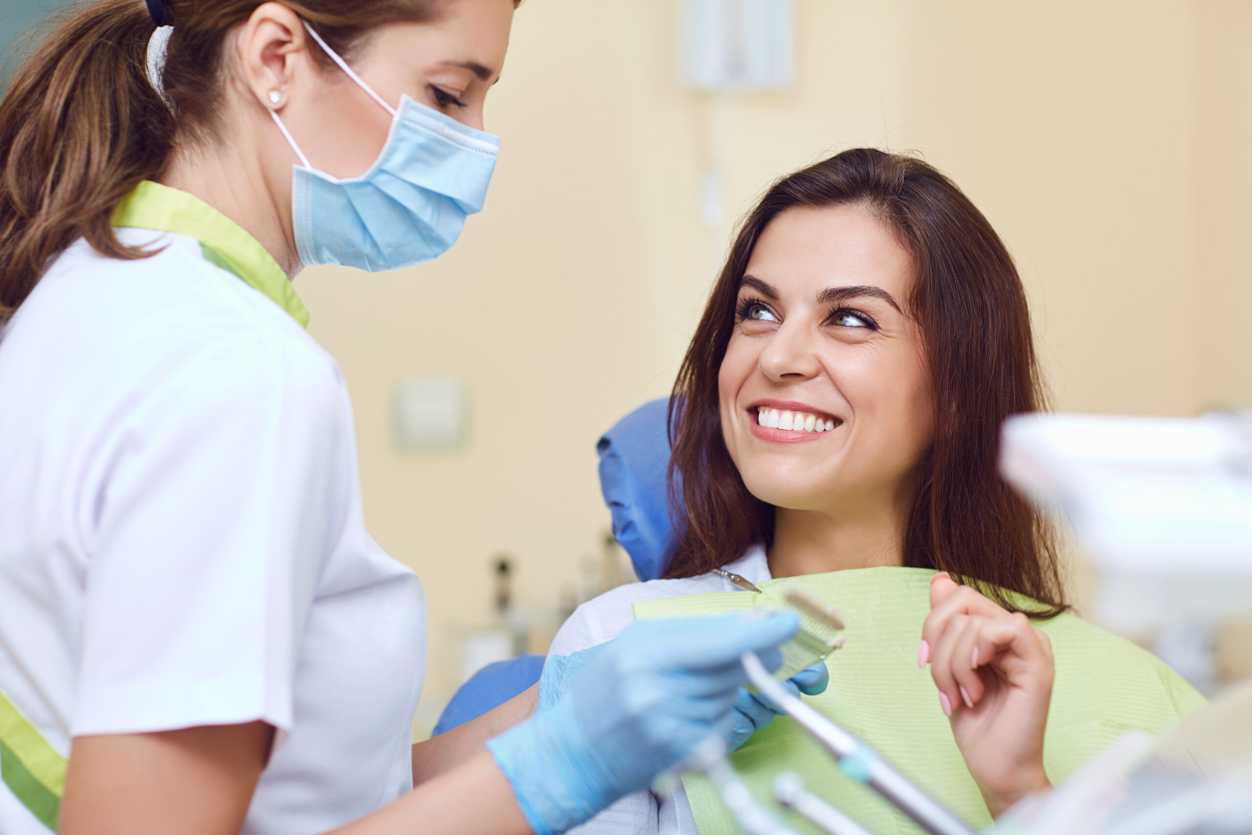 Closeup of a young woman with beautiful smile at the dentist