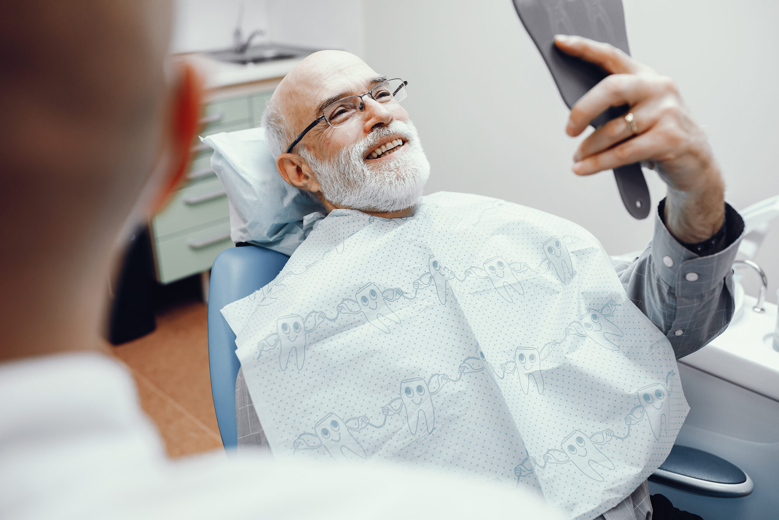 Old man sitting in the dentist's office