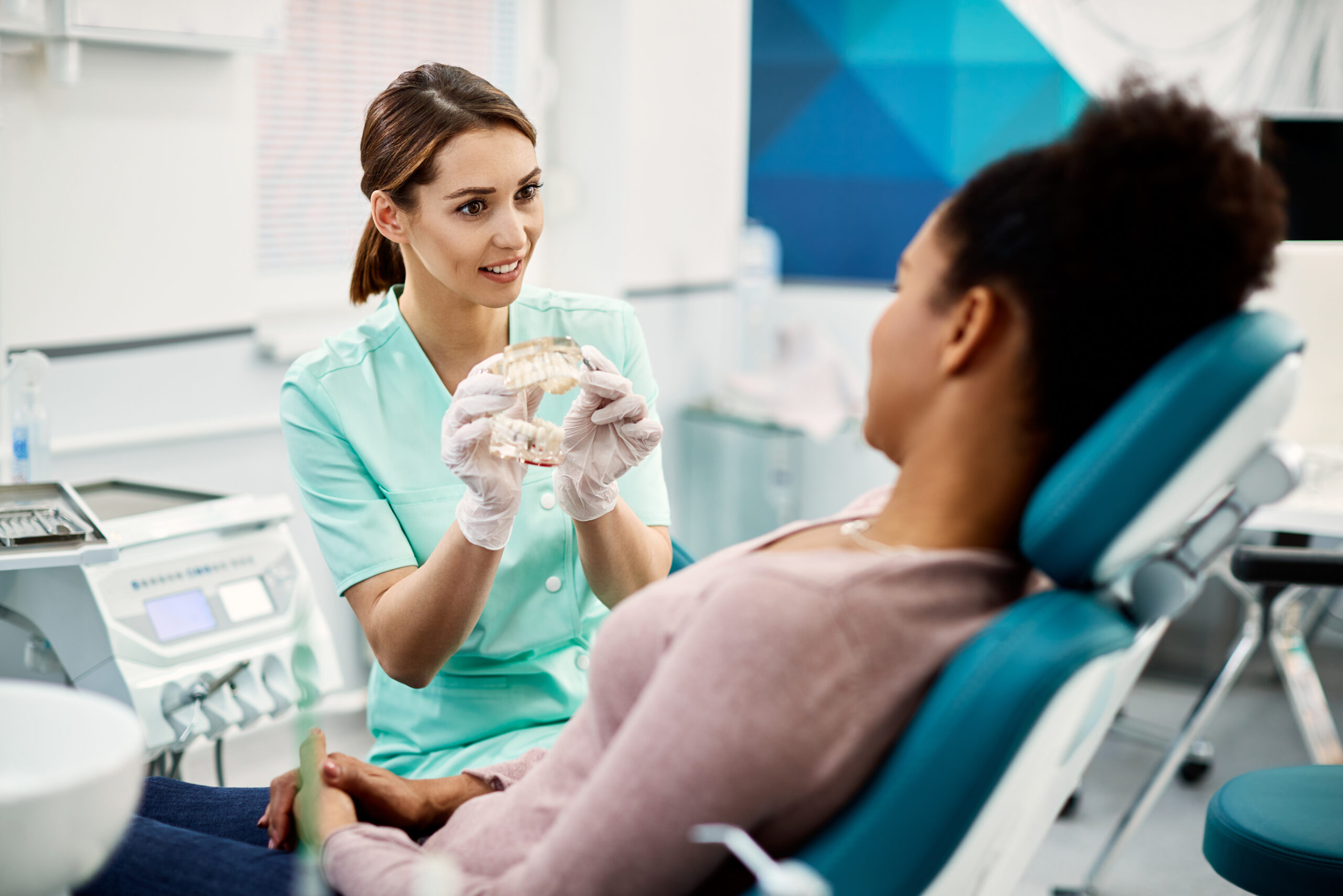 Female dentist communicating with a patient about mouthguards at the clinic