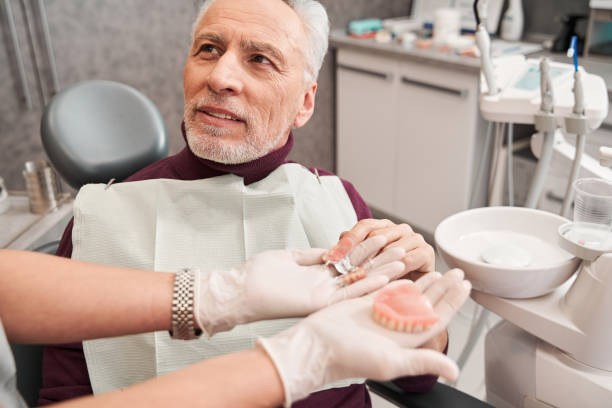 elderly man during the medical examination with female dentist in the dental office